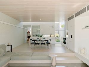 Open kitchen and dining space with timber ceiling boards and step down to lounge
