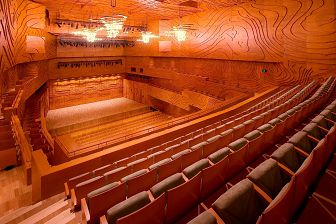 Empty seats inside the auditorium of the Elisabeth Murdoch Hall with a view of the stage, the entire venue is wood