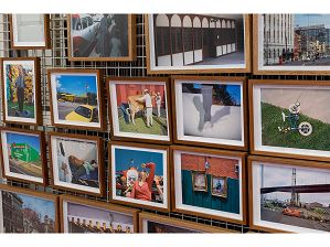 Selection of framed colour photographs on display as part of the picture racks in the City of Melbourne's Art and Heritage Collection store. Photographs featured are by various artists and include streetscapes, cityscapes and portraits.