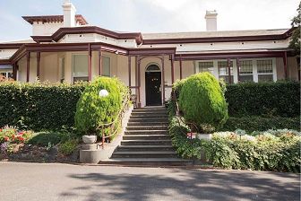 A photo of the current day bluestone entrance steps to the front door of the Bed & Breakfast. 
A photo of the 'Umina' dining room showing an example of how a table would be set for a  High Tea.