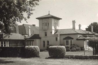 A black and white heritage photo of the tower and the side of Umina taken from the manicured Edna Walling garden prior to the extension of the Bed & Breakfast being built.