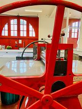 The Firestations vibrant bright red original doorway and our three etching presses situated in the main studio.