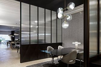 Meeting room with reeded glass and black frames.