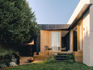Modern Rear Extension with concrete panels, black charred timber, a deck and pine trees