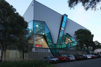 Colour photograph of colour glazing in the form of an angled ribbon wrapping the exterior of the building.