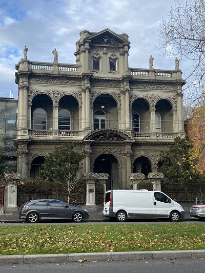 The exterior of the triple storey elaborate grey rendered nineteenth century Italianate style building originally known as 