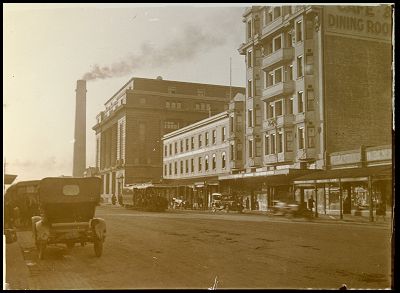 Heritage sepia image from the 1800's of the Mail Exchange building looking down Bourke Street which is a dirt road.