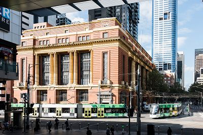 The Mail Exchange building looking across Spencer Street from Southern Cross Station with a tram going past