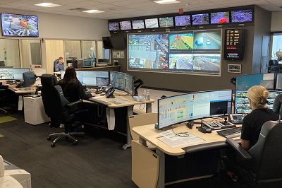 Staff sitting at desks with computer screens around them viewing traffic in the CityLink traffic control room.