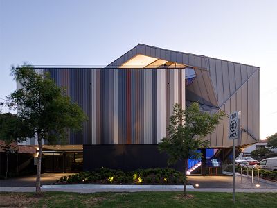Photograph of the Justin Art House Museum exterior at dusk.