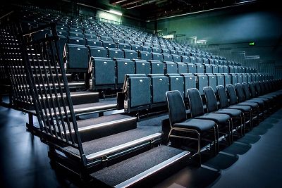 Interior shot of the new theatre seating bank, rows of black padded seats for audiences to watch theatre or listen to live music.