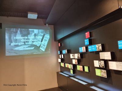 Image of a large black and white image on the wall in the Settlement Section of the Museo Italiano Exhibition from the 1962 Giorgio Managiamele film 