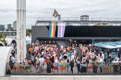 A drone-shot of the Sunday Sizzle event on our rooftop showing a drag queen waving a rainbow flag.