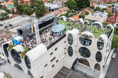 A drone-shot of the Sunday Sizzle event on our rooftop showing a large crowd of people.